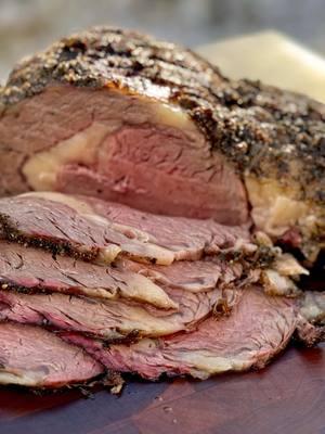 Holiday Herb Encrusted Tallow Prime Rib on the BGE Here’s an incredible holiday BBQ recipe for an herb encrusted bone-in prime rib, incorporating beef tallow to enhance flavor and juiciness. This method ensures a smoky, tender roast with rich umami flavors. Order your @Colorado Craft Beef  🥩  Prime Rib and Tallow now to ensure delivery before the holidays! Ingredients (Serves 8–10) - [x] 1 bone-in prime rib roast (6–8 lbs) - [x] 3–4 tbsp coarse kosher salt - [x] 2 tbsp freshly ground black pepper - [x] 2 tbsp fresh rosemary (finely chopped) - [x] 2 tbsp fresh thyme (finely chopped) - [x] 2 tbsp parsley (finely chopped) - [x] ½ cup beef tallow (melted) - [x] 3–4 cloves garlic (minced) Instructions- Rub: Combine thyme, rosemary, parsley, salt, black pepper, minced garlic, and beef tallow into a bowl. Warm on the grill until softened. Prep the Roast: Separate the meat from the bone then rub the roast with a thin layer of the melted herb beef tallow mixture. Smoking the Prime Rib: Set up your @biggreenegg  - [ ] Set for indirect heat - [ ] Preheat to 225°F and choose wood like oak or hickory for a bold flavor. - [ ] Smoke it: Place the roast directly on the smoker grate, bone side down. Reverse Sear: - [ ] When the internal temperature reaches 120°F (for medium-rare), remove the roast from the grill. - [ ] Rest it: Tent the roast with foil and let it rest for 20 minutes. - [ ] Increase your grill or smoker temperature to 500°F. Sear the roast for 5–7 minutes to form a crust, flipping halfway through. Enjoy this luxurious holiday BBQ dish with your signature cocktail for a perfect feast! - - #primerib #holidayrecipes #beeflover #bbqtiktok #coloradocraftbeef 