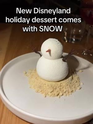 ❄️☃️CUTE and delicious holiday dessert now available! Look at how fun this is with the snow dusted on top. This is called the SNOWMAN. It’s described as yogurt streusel, rosemary ice cream, tangerine mousse, orange peel, cardamom cake. Costs $15.  Find this dessert at Paseo in Downtown Disney. You can CLICK THE LINK in my bio for a free printable of all the best Disneyland Christmas foods. The best part about this is that it actually tastes very good. I loved the ice cream base. #disneyland #downtowndisney #disneyfoods #disneytreats #disneylandfood #disneylandchristmas