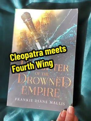 Cleopatra meets Fourth Wing in this romantic fantasy series with forbidden romance, political intrigue, and slow burn spice. Best of Booktok #1 in Historical Fantasy #1 Greek and Roman Myth and Legend Barnes and Noble Blog Top Five Indie Fave Lady Lyriana Batavia is third in line to the Seat of Power in Bamaria: a position of wealth and privilege, but not safety. Bamaria falls under the rule of the Lumerian Empire, survivors of a celestial war whose island sank in the Drowning. Now all Lumerians submit to the Emperor and his strict laws about magic. He decides what magic can be practiced and what powers remain forbidden. He decides who will die for possession of forbidden magic. Lyr’s own cousin was executed for wielding the wrong kind. And for years, Lyr has sworn to protect her older sisters, helping them conceal their own illicit magic. But when Lyr must participate in the ceremony that reveals her power, she uncovers something else entirely. Something that means banishment from the Empire. Faced with death in exile, and leaving her sisters behind, Lyr has no choice but to accept a deadly contract. She has seven months to train as a warrior and pass the Emperor’s brutal test of strength, without magic. But when she’s forced to train with Lord Rhyan Hart, the man she’s secretly loved since she was a girl—a feared warrior in exile himself, forbidden to her in every way—she’s in danger of losing far more than her family, life, and country. Rebel forces, and an invading army, are destabilizing Bamaria, just as her family’s secrets threaten to reveal themselves. Surviving the training, and saving her sisters may mean sacrificing her own heart. Daughter of the Drowned Empire is the first book in a sensational romantic series featuring a riches-to-rags heroine, dangerous court politics, and a forbidden slow-burn romance. Perfect for fans of Jennifer L. Armentrout, Danielle L. Jensen, and Rebecca Yarros. 'One fantastical world. One fierce heroine to take it down! Daughter of the Drowned Empire is sexy, thrilling, and pure magic!' Cecy Robson, author of Bloodguard DAUGHTER OF THE DROWNED EMPIRE by Frankie Mallis is a breathtaking and sumptuous fantasy romance that had me kicking my feet, gasping for air, and blushing from the first page to the last. Filled with intriguing court dynamics, the world feels completely fresh and immersive. Lyr is a flawed and lovable heroine you can't help but root for, giving vibes of a magical Cleopatra. One of my favourite reads of the year! ― Elizabeth Helen, author of Bonded by Thorns #bookish #bookboyfriendsdoitbetter #romanticfantasy #romanticfantasybooks #romantasy #romantasyreads #forbiddenromancebooks #slowburnromance #fantasybookrecs #bookrecs #romantasytok #whodidthistoyou 