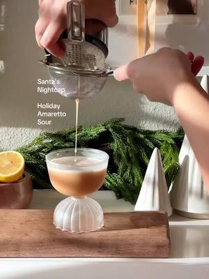 Let’s call this… Santa’s Nightcap 🎅🏽 It’s an Amaretto sour but with a couple twists and turns. Don’t worry it’s all in holiday flavor and fun. Here’s how to make it at home To a cocktail shaker add in 1 egg white 3/4 oz lemon juice 1/2 oz cranberry cinnamon syrup, see broadcast channel for full recipe 1.5 oz amaretto 1/2 oz rye whiskey, or bourbon will be more sweet! 1/2 oz fernet Now, dry shake it all together. Add ice and shake again! Double strain into a chilled glass. Garnish with a star anise & nutmeg on top Happy holidays, cheers #cocktailrecipes #amaretto #amarettosour #holidayrecipes #christmasdrinks #christmasrecipes 