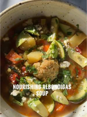 NOURISHING ALBONDIGAS SOUP🍲 Growing up albondigas soup, also known as Mexican meatball soup, was a staple in my home. And today I’m sharing my own spin. This albodnigas soup is loaded with all the nourishing items to fuel your body right. And makes for the perfect meal to meal prep ahead, to have ready for your weeknight dinners. I hope you love it! Albondigas Soup Soup: 1 Tbsp olive oil 1 small yellow onion chopped 2 carrots chopped 3 celery stalks chopped 2 peeled and chopped russet potatoes 2 zucchini’s chopped  8 cups chicken bone broth Salt + pepper to taste 1/2 tsp cumin 1/4 tsp turmeric 1/2 tsp dried oregano 4 garlic cloves minced 15 oz diced petite tomatoes  2 bay leaves Albondigas (Meatballs): 1 large egg beaten 1 lb ground turkey (can use chicken or beef too) 1 1/2 tsp salt 1/4 tsp ground pepper 1/4 tsp coriander 1/4 tsp turmeric 1 tsp cumin 1 1/2 tsp dried oregano 1/2 tsp chili powder 3 garlic cloves minced 1/3 cup diced cilantro 1 Tbsp chopped mint  1/4 cup long grain organic rice Instructions: 1. Prepare your meatballs by mixing all the ingredients with the ground turkey. Form into small bite size meatballs and set aside 2. To a large pot add oil and warm through. Add diced onions and sauté for 5 minutes. Add the chopped carrots and celery and sauté for another 5 minutes. 3. Add minced garlic, seasonings, and sauté for a minute or so 4. Add the diced tomatoes, potatoes, bone broth, and bring to a boil 5. Once boiling add the meatballs, 2 bay leaves, cover pot, reduce to a low simmer, and cook for 20-25 minutes 6. Once done, add the chopped zucchini and let it continue to simmer until the zucchini’s have softened 7. Top with cilantro, avocado, and cotija cheese . . #albondigas #albóndigas #albondigasoup #soupseason #soups #souprecipe #mexicansoup #comfortfoods #souprecipes #meatballsoup #soupweather #souplover #homemadesoup #nourishingfood