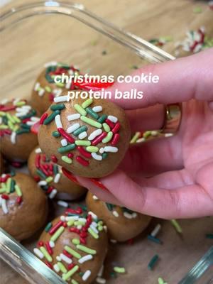 CHRISTMAS COOKIE PROTEIN BALLS 🎄recipe below! INGREDIENTS:  - 3 scoops vanilla protein powder (~1/2 cup) - 1/4 tsp ground cinnamon  - A pinch of sea salt  - 1/2 tsp almond extract  - 1/2-3/4 cup almond butter (depending on consistency)  - 1/4 cup maple syrup  - Sprinkles of your choosing!  INSTRUCTIONS:  - in a large bowl, add your protein powder, cinnamon and sea salt. Give it a quick mix. - Then add in your wet ingredients: almond extract, almond butter and maple syrup.  - Mix until everything is well combined and formed into one giant ball.  * if the consistency is slimy, you can ALWAYS add in more protein powder. Almond butter consistencies can vary so it’s hard to say a perfect measurement for everyone.  - then form into smaller balls and place in a glass container.  - On a small plate, pour your sprinkles. Gently press the top of the protein ball into the sprinkles then place back in the glass container.  - Store in the fridge and enjoy within 3-4 days! (They won’t last that long, promise 😉) @EarthChimp Protein Powder @Simply Organic @H-E-B #proteinballs #christmasrecipe #christmastreats #proteinpacked #proteindessert #highprotein #proteinsnack 