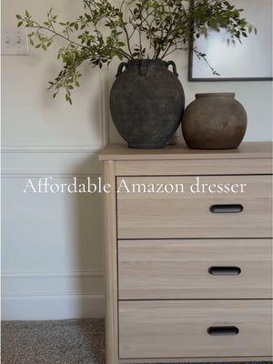 Under $300 dresser from @Amazon! I had been debating this purchase for so long to replace our boring white dresser, and I’m sooo glad I finally bought it! The wood tones warm the space up and TRULY makes our master feel finished!  🔗 in my b i 0!  #masterbedroomstyling #masterbedroom #dresserstyling #amazonhome #amazonfinds #amazonfurniture  @Amazon Home 