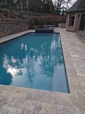 16'x36' rectangle pool with raised Perimeter Overflow Spa and silver travertine coping and decking in Alpharetta GA. #artisticpools #luxurypools #gapoolbuilder #pools #pool #swimmingpool #poolman #pebbletec #poolmanluke #tnpoolbuilders #masterpoolsguild #jandypoolproducts #infloorcleaningsystem #masterpoolsguild #swimmingpools #poolparty #poolguy #fyp #foryoupage 