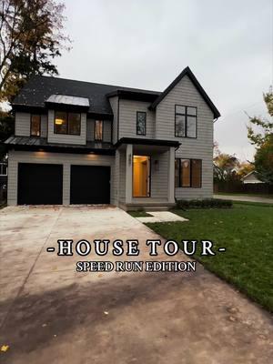 This designer-level home features custom millwork, including wood beam ceilings, and a fluted wood marble surrounded fireplace. The open layout allows the living room to seamlessly flow into the kitchen. The primary suite includes his and her closets and a spa-like bathroom.  #newbuild #housetour #customhomes #homebuilding #michiganrealestate 