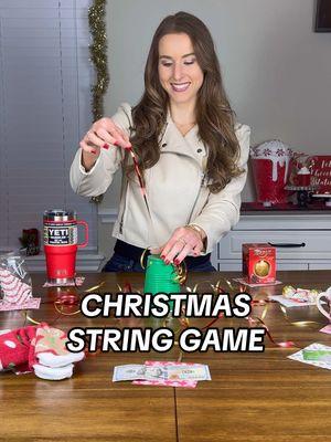 CHRISTMAS STRING GAME 🎁 This game is so fun for any age and customizable! From gag gifts and coal to money and lottery tickets- you can add all types of prizes. And yes I realized I probably should’ve had one color ribbon since my grand prize was $100 lol. SUPPLIES: -Plastic cup -Knife -Curling ribbon -Christmas paper -Scissors -Tape -Prizes INSTRUCTIONS: 1. Carve an ‘X’ onto the bottom of your plastic cup with a knife. 2. Pull your ribbon through.  3. Cut your Christmas paper into squares and tape to each ribbon. 4. Spread out your ribbons on a large, flat surface and place your prizes on top. 5. Take turns pulling a string to win! #stringgame #christmasgames #christmasgames #christmasgamenight #christmasideas #christmasparty #christmaspartyideas #christmaspartygames #christmasfun #christmashosting #christmasfamilytime #christmasfamilyfun 