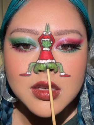 Merry Crisis everyone! 🎅🏼🎄💚 What do we think of this version?! I like it better!!  Makeup deets: @Blend Bunny Cosmetics @Taj little miss she never misses palette for eyes & grinch  @Glisten Cosmetics LTD @linsmakeuplooks wet liner palette for the grinch + chroma gloss in phoenix  @fwee official ambitious pudding pot for blush  @Kaleidos Makeup space age moon cruiser highlight + Solaris & limelight epiphany eyeliners  @Huda Beauty cookie dough faux filter concealer + easy blur primer  @about-face beauty LM2 olive performer foundation  @milkmakeup stoked contour stick + kush brow gel in grind  . . . #christmas #christmas2025 #thegrinch #grinch #makeupfilter #creativemakeup #makeupinspo #holidaymakeup #grinchmakeup 