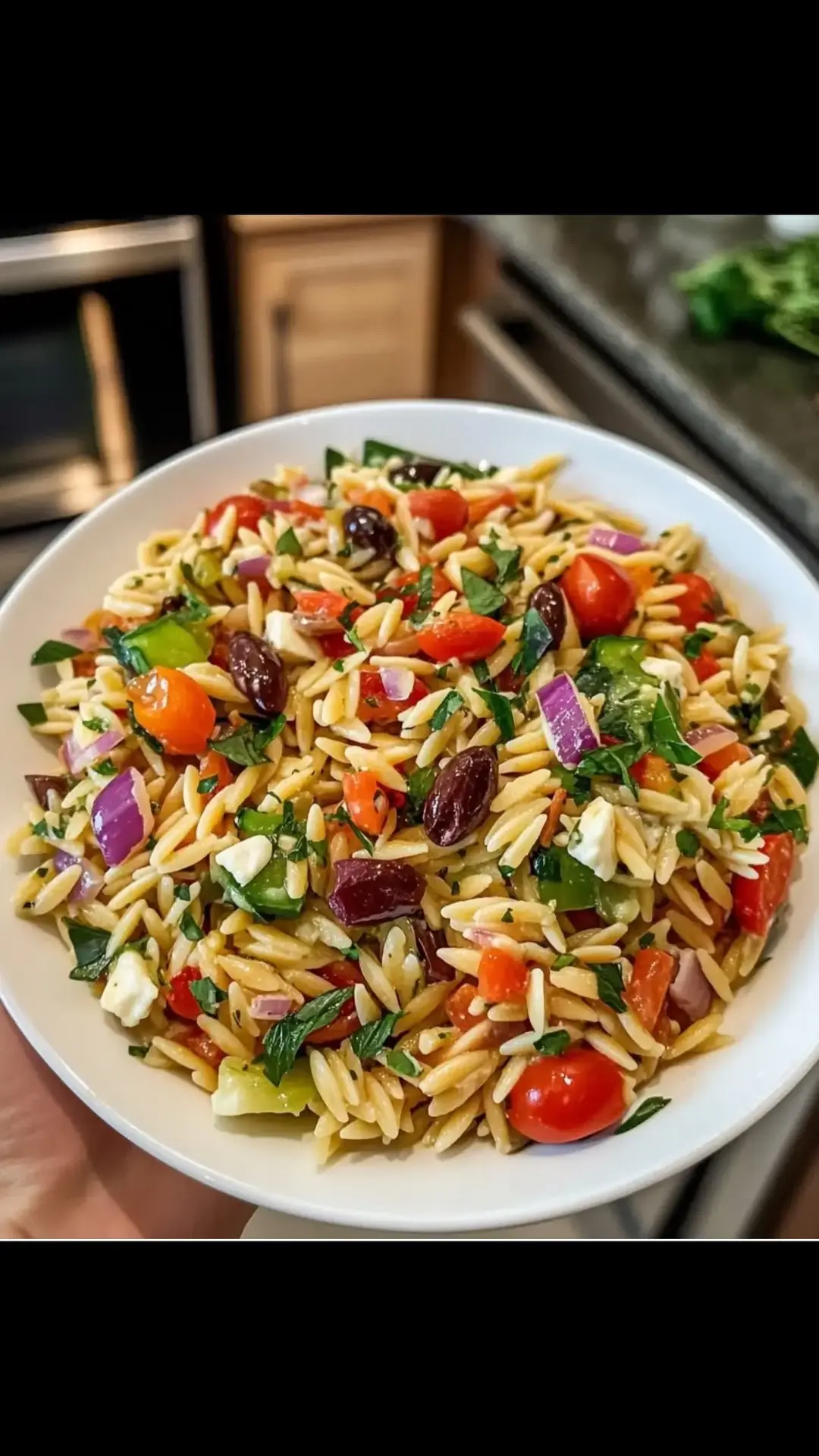 A refreshing Mediterranean-inspired salad loaded with tender orzo pasta, fresh veggies, tangy feta cheese, and a zesty olive oil dressing. Perfect for any occasion! Ingredients: 1 cup orzo pasta 2 cups water 1 cup cherry tomatoes, halved 1 cucumber, diced 1/2 red onion, finely chopped 1/2 cup Kalamata olives, pitted and sliced 1/2 cup feta cheese, crumbled 1/4 cup fresh parsley, chopped For the Dressing: 1/4 cup olive oil 2 tbsp red wine vinegar 1 tsp dried oregano Salt and black pepper, to taste Directions: 1️⃣ Cook the Orzo: Bring water to a boil in a medium saucepan. Add the orzo pasta and cook according to package instructions, about 8-10 minutes, until al dente. Drain the orzo and rinse under cold water to stop the cooking process. Set aside to cool. 2️⃣ Prepare the Salad Base: In a large mixing bowl, combine the cherry tomatoes, cucumber, red onion, Kalamata olives, feta cheese, and fresh parsley. 3️⃣ Make the Dressing: In a small bowl, whisk together olive oil, red wine vinegar, dried oregano, salt, and black pepper until well combined. 4️⃣ Assemble the Salad: Add the cooked and cooled orzo to the bowl with the vegetables. Pour the dressing over the salad and toss gently to combine all ingredients evenly. 5️⃣ Serve: Let the salad sit for at least 15 minutes to allow the flavors to meld. Serve chilled or at room temperature, and enjoy this light and flavorful dish! Prep Time: 10 min | Cook Time: 10 min | Total Time: 20 min Servings: 4 | Calories per Serving: ~320 kcal. #pasta #pastatiktok #pastarecipe #pastasalad #greeksalad 