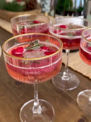 Wreath Mimosa - an easy and festive cocktail!! Using and ice cube tray, add anything you want. I used: Raspberries Pomegranate Seeds Rosemary But cranberries, strawberries, or other things work well too! Fill with liquid (can be just water). I used: Cranberry Juice Water Simple Syrup (if cranberry cocktail no need for this) Freeze. Pour over your favorite champagne. I used: @decoywine Enjoy!! #cocktail #mimosa #champagne #wreath #festive #fyp #viral 