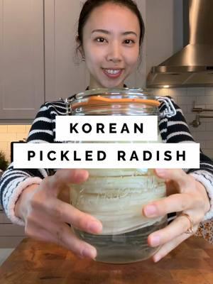 Pickled Korean radish or ssam mu recipe ⬇️  1 medium Korean radish (can also use daikon) 2 cups water 2 cups vinegar 2 cups sugar 2 tbp salt 1. Rinse and peel the radish 2. Cut off both ends 3. Carefully slice the radish using a mandoline (I stop slicing it before it gets to the end of the radish) 4. Put the radish into a clean air-tight glass jar 5. In a small pot, mix sugar, water, vinegar, and salt 6. Take it to the stove and stir until the sugar and salt dissolves. 7. Pour the brine into the radish. It’s okay if the liquid is warm. 8. Let it cool at room temperature and refrigerate it. I wait until the next day to eat it. 9. I eat it all within a week.  #koreanfood #radish #pickled #koreanbbq 