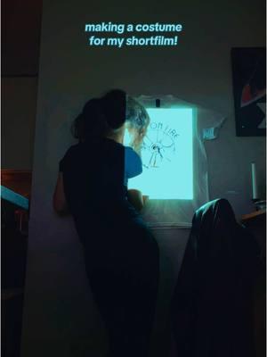 making a costume for my short film! I designed a logo and then used a projector to project that logo on the wall. The , I hung a tshirt in place and traced the design with fabric paint :) #art #filmmaking #filmtok #filmmaker #costumedesign #skelecide 