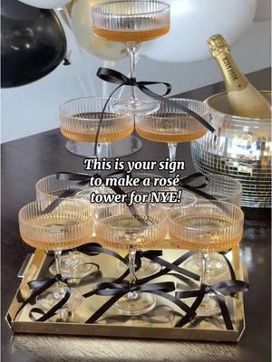 Impress your guests with a champagne tower for NYE!🥂 These coupe glasses are perfect for stacking! Bonus points if you add bows 😍🎀  Want to recreate this? 🔗s to everything here are on my L T K 🫶🏻 #creatorsearchinsights #newyearseve #newyearsparty #nye #champagnetoast #champagnetower 