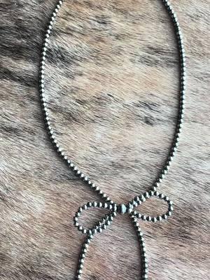 The new Bossier Bow Navajo Pearl Necklace made with authentic Navajo Pearls is amazing! Only 1 available! www.westernbydesignboutique.com #navajopearls #western #westernstyle #westernjewelry #jewelry #authenthic #cowgirl #cowgirljewelry #bowjewelry 