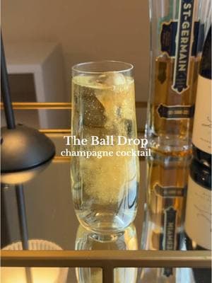 The Ball Drop - champagne cocktail for NYE! 🍾🥂✨ A simple New Year’s Eve cocktail that is still a showstopper with a fun glitter-ized ice cube that you can drop into your cocktail for some extra pizzazz!  Add 1/2 oz of elderflower liqueur to your champagne flute, then top with sparkling wine. I used @Fancy Sprinkles® edible glitter pump to cover a round ice cube (I get my round ice cube trays from Amazon!) and then dropped it into my cocktail to watch the sparkles swirl.✨ I was inspired by @liv.yah’s  adorable cotton candy glitter cocktail that she created for NYE last year & wanted to add my own twist on the concept! Cheers & enjoy these last few days of 2024, friends! 🤗🫶🏼 #thespritzeffect #newyearseve #nye #cocktail #newyears #newyearscocktails #elderflower #champagne #champagnecocktail 