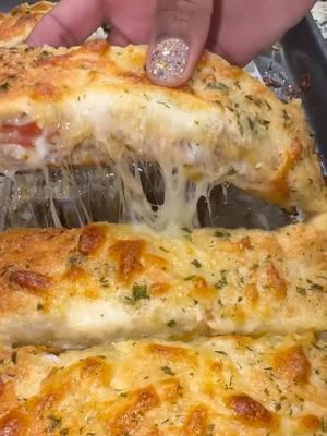 I made a lot of recipes this year! Heres one of my top 5. Plus it’s Perfect for your NYE appetizer menu. Let me know if you try it out.  Stuffed cheesy garlic breadsticks🤤 Recipe ⬇️ -Classic pizza crust  -mozzarella  -Parmesan  -melted garlic butter -turkey Italian sausage  -turkey pepperoni  #clubbkitchenbykiaj #Foodie #cheesy #reels #recipes #cheesy #instagood