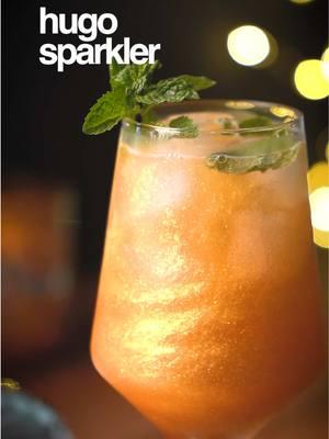 Spritz 🤝🏼 Sparkles ✨ HUGO SPARKLER ✨ - 1oz elderflower liqueur  - 1oz sparkling water  - 4oz Prosecco - 3-4 mint leaves - Edible glitter  Add ice, mint leaves and edible glitter to a spritz glass then combine elderflower liqueur, sparkling water and Prosecco. Stir and garnish with a lemon wheel and mint sprig.  21+ to enjoy 🥂 #hugospritz #nye #newyearseve #newyear #neeyearseveparty #cocktail #cocktails #spritz