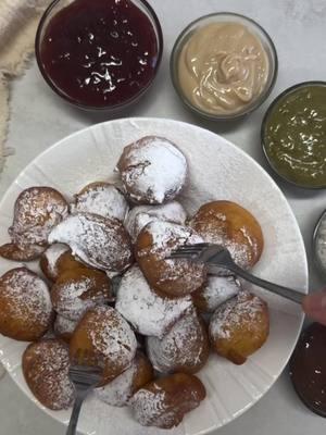 5 Minute mini donut recipe by @opalester_oren Powdered sugar All your favorite sweet spreads Batter: 2 eggs 14 ounces/400 milliliters sour cream 3 tablespoons/15 grams sugar 1 teaspoon/10 grams baking powder ½ cup/120 milliliters milk 3 cups/360 grams all-purpose flour Heat oil in a deep pan over medium heat until it reaches 165°C (330°F). In a large bowl, whisk together all the batter ingredients until smooth and well combined. Using an ice cream scoop or two spoons, carefully drop small portions of the batter into the hot oil. Fry, turning occasionally, until the doughnuts are puffed and golden brown, about 4 minutes. Transfer the doughnuts to a wire rack to cool slightly. Dust generously with powdered sugar and serve warm with an assortment of sweet dips. #minidonuts #minidonutrecipe #minisufganiyot #sufganiyot #hanukkah #jewsihfood #jewishrecipes #jewishholidays