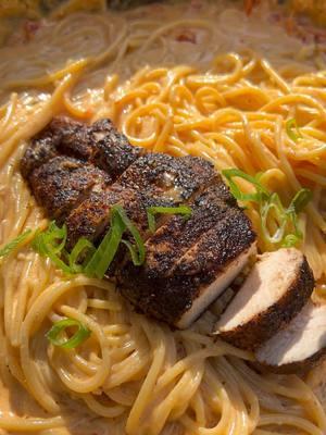 This one is still one of my all time favorite recipes 💯 . Cajun Chicken Alfredo Pasta 🐓🍝 Ingredients • 1.5 lbs. chicken breasts, boneless • ½ - 1 C blackening seasoning (I used @spiceology Black Magic rub) • Olive oil as needed • 3 T minced garlic • 1 (7 oz.) jar sun-dried tomatoes, drained & chopped • ¼ C white wine • 3 C heavy cream • ¾ C shredded parmesan • 1 lb. cooked spaghetti • ¼ C scallions For the Chicken: 1. Preheat both griddle burners to sear mode. Meanwhile, lightly apply olive oil to the chicken breast to act as a binder. Season the chicken breast liberally with blackening season until the chicken is well coated.  2. Once the griddle has preheated, add the chicken and cook for 15-20 minutes, flipping halfway through (leave one side of the griddle open to allow room to cook the sauce a the same time). Once the internal temperature registers 165 degrees, transfer the chicken to a plate and set aside until ready to use. For the Cajun Alfredo Sauce: 1. Place a large skillet with a splash of olive oil on the open side of the griddle. Once the skillet becomes hot, add garlic and cook until fragrant, about 1 minute. Next, add the sundried tomatoes and cook for another minute or so. Deglaze the pan with the white wine, then add the heavy cream and 2-3 T blackening seasoning. 2. Bring the mixture to a boil, then lower the heat to 350 degrees and continue cooking until the sauce has reduced and become spoon thick. Add in the parmesan cheese and stir until the cheese is melted and well-incorporated. Throw in the spaghetti and toss until the pasta is coated with the Cajun sauce and turn off the burner. To Finish: 1. Allow the chicken to rest for 5-10 minutes. Using a sharp knife, slice the chicken into ¼ - ½ inch thick slices. 2. Add the Cajun alfredo pasta to a plate with the carved chicken. Top with scallions, serve, & enjoy! . #chicken #chickenbreast #chickenalfredo #cajun #cajunchicken #cajunfood #deliciousfood #pastarecipe #pastalovers