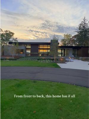 From the front, this home makes a strong impression with its minimalist design and beautiful landscaping Inside, high ceilings, an open floor plan, and expansive windows showcases the backyard that completes this luxury home with a pool and fire pit area perfect for outdoor living #lakesidehome #lakesideliving #architect #azdarchitecture #interiordesign #homedesign 