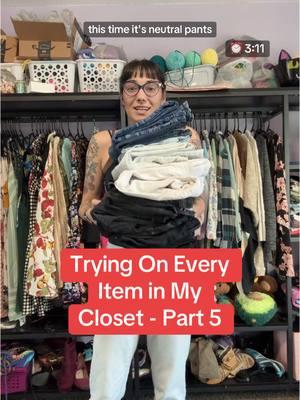 Stay til the end for a special bonus! Trying on Every Item in My Closet - Part 5 - Neutral Pants #ClosetTour #TryOnHaul #StyleInspo #ManicChangeling #ClosetCleanOut #OpenConceptCloset #PantsTryOn #Pants #ThriftedFashion #Thrifting  Video length: 3 minutes 11 seconds. Video description: Liddi, a slim person with tan skin and black hair tied back except for bangs is speaking to the camera while holding a stack of folded pants. The background is an open concept closet. She wears glasses and has colorful arm tattoos. Throughout the video she tries on pants with verbal descriptions. Numbers 7 and 9 are both black. 