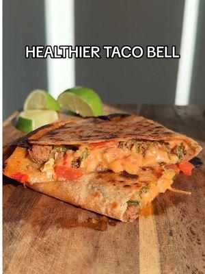 HEALTHIER VERSIONS OF MY FAVORITE FOODS (COPYCAT CRUNCHWRAP SUPREME)  This recipe takes me back to my college days when I used to loveee Taco Bell but didn’t love how I felt after eating. This copycat Crunchwrap Supreme is made with better for ingredients, is gluten free and can be made dairy free! Recipe: (makes about 6 quesadillas) -avocado oil spray (to spray pan after each tortilla) -@Siete Foods grain free tortillas, burrito size (sometimes they can be found in the freezer section at grocery store, but any burrito tortillas will work) -1 pack @siete taco seasoning  -@Primal Kitchen Foods plant based queso -sour cream or dairy free sour cream or greek yogurt -1 yellow onion, diced -1lb grass fed beef -shredded cheese of choice -lettuce, chopped -cherry tomatoes, sliced in half How to: -first sauté onions in a large skillet over low/medium heat -next add ground beef and taco seasoning to the same skillet with onions and cook until browned -assemble tortillas with queso, sour cream, beef + onion mixture, cheese, lettuce and tomatoes -spray the same skillet with oil and carefully place the whole tortilla flat on skillet, cook the entire tortilla for 2-3min on medium heat before folding over one side (this will make the tortilla more pliable) -cook each side of tortilla for about 3-5min or more depending on crispy you like it (see video on how I flipped the tortilla using a plate)  -once done place quesadilla on cutting board or plate and cut into it, serve with lime or hot sauce and enjoy! #easyhealthyrecipes #healthyrecipes #crunchwrapsupreme #tacobell #quesadilla #glutenfreerecipes #dairyfreerecipes #healthierrecipes #healthydinnerideas #dinnerinspo 