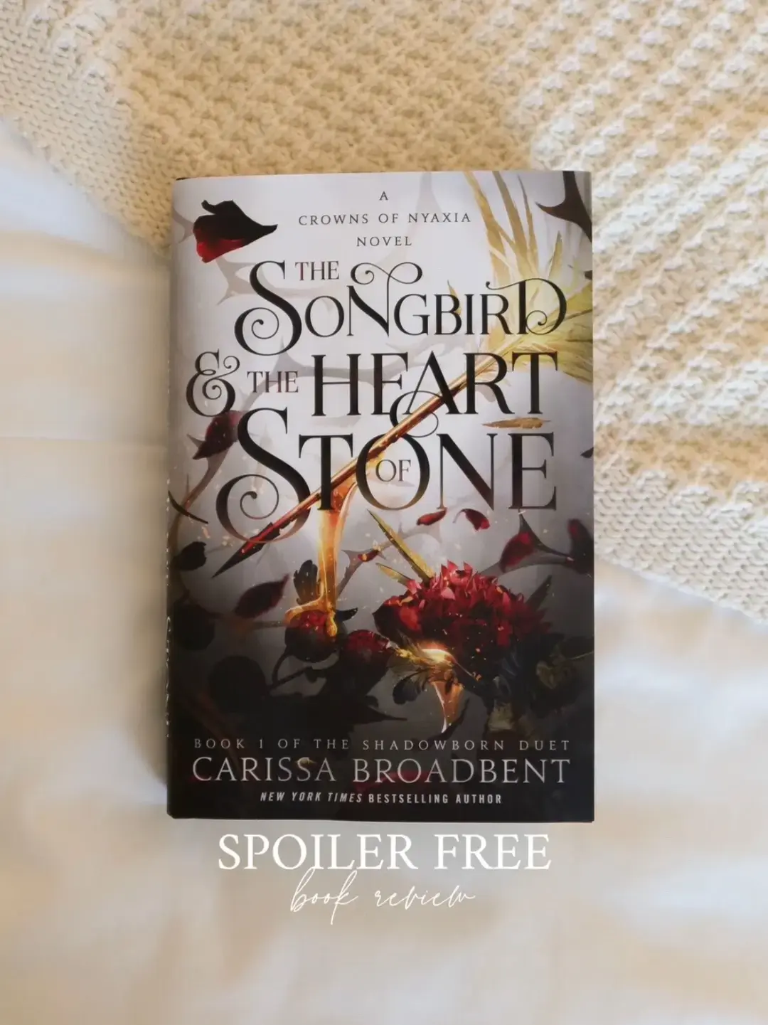 the songbird and the heart of stone recently came out! this is the third book in the crowns of nyaxia series by carissa broadbent ⚔️  i’ll forever be a fan of carissa’s writing style. i love that the sections start with memories of her character’s past and how it connects to the present that we’re about to explore  this was a book about self discovery to me. self realization. finding your own power. self acceptance. owning your past and not letting it define you. a story of sacrifice. of healing. of love  i expect a twist at the end of her books, but this one had me shrieking out loud and kicking my feet to the point i woke up my husband lol  this book ended with the perfect platform to launch into the sequel. i have zero idea where she’s going to take the story, and i love that she’s not so predictable with her writing  very interesting concept with them trekking the levels to the underworld, and i always love reading her descriptions of the gods, especially nyaxia. gives me chills! #BookTok #bookreview #crownsofnyaxia #thesongbirdandtheheartofstone #carissabroadbent #bookish #bookworm #bookrecommendations #bookrecs #romantasybooks #mische #mischeandasar #bramblebooks #fantasybooks #annotatedbooks #annotations #signedbooks #brambleromance #charterbooks @Carissa Broadbent @BrambleBooks @Charter Books 