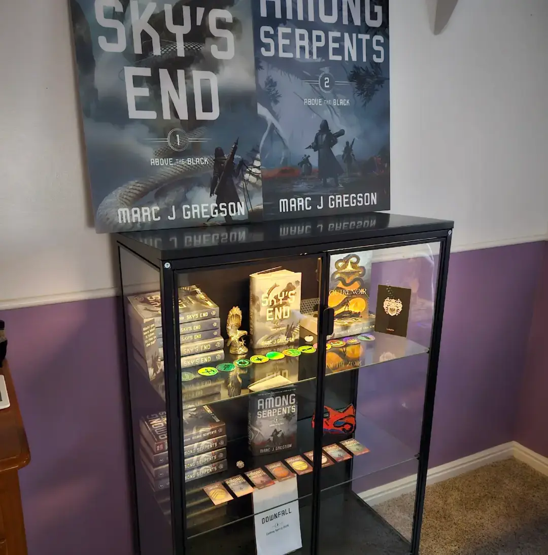 Years ago, my wife asked me what my ultimate goal was with getting published, and it was at the time, simply being able to hold my book and say, “I did it.” I also mentioned that I wanted an official display where I could show it off to my friends and family. For over a year now I’ve kept my books on a shelf in my office, but I always wanted something that had an almost museum-like quality to it. A trophy case, if you will. With the release of AMONG SERPENTS imminent, I felt now was the time to take the leap off the starboard bow and create the display. This bookcase is still a work-in-progress. I have multiple foreign releases still forthcoming for the trilogy, and DOWNFALL is still a year off. But I think this is a nice start, don’t you? . . . #bookcase #bookdisplay #BookTok #fantasytrilogy #displaycase #authors #author #books 