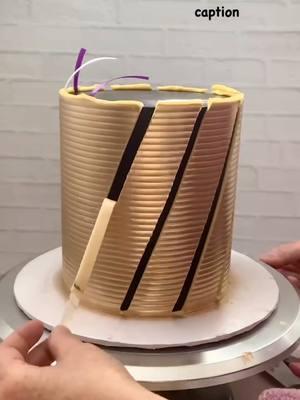 New Year Cake tutorial 🎊🥳🎉 Have your cake final coated ready, cold and the buttercream is firmed  Cut the ribbon, measure it a bit longer than the height of your cake. Attached them diagonally, make sure it’s straight and stay flat to the cake. I know some of mine especially the purple one are crooked😩 Pipe mustard color buttercream with piping bag over it, make sure you have enough bc. I was short on the mustard bc but I made it work 😆 Smooth it out with smooth hound cake comb and since I want extra texture so I use Micro Scallop Cake comb to add texture. Then I use gold luster with airbrush machine to add gold sparkling finish. Mix the gold luster dust with lemon 🍋 extract, not too runny and not too thick consistency.  Peel the ribbon RIGHT AWAY when your gold buttercream STILL SOFT.  You need to work fast and get everything ready when you work with ribbon pull technique. Clean the excess buttercream on top perimeter and decorate as you like  Swiss meringue buttercream frosting is used to decorate this gorgeous cake.  Gold smooth hound and Micro scallop cake comb from Estercakes.com Cake stand from @opulenttreasures  Use code : Ester20 for discount  Sprinkles from @manvscakes  Use code : ESTER25 for discounts  Gold dust from @cakesbyangelamorrison #esterscomb #goldsmoothhoundcomb #2025 #cakedecorator #cakelover #happynewyear #cakeartist #tiktok #fypシ #videotutorial #tutorial #behindthescenes 