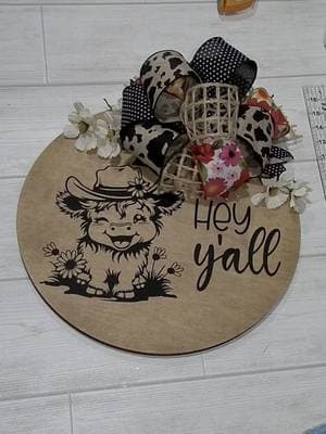 The cutest little highland cow ever. I made this live on tiktok a few days ago. sign makers can grab this design in my Etsy shop now. I also have a bow tutorial pinned if you want to learn how to make a bow. DM me to order a sign made by me.  I get my rounds from @Mama’s Rustic shack. give her a follow for updates on new shapes and stock availability.  Starmask stencil vinyl is from @My Craft Source - use code KARA at checkout to save.  #woodsignshandmade #woodsigns #doorhanger #svgfiles #doorhangersoftiktok #signmaker #doorhangers #welcomesign #doorsigndiy #doorsign #doorhanger #highlandcow #highlandcows #heyyall #bowtutorial #farmhousedoorhanger #farmhousedecor #handmadedecor #frontdoordecor 