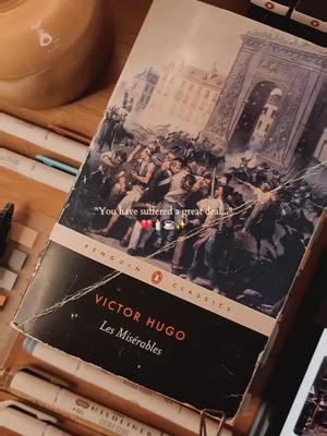 Jean Valjean has finally been introduced, and his story is absolutely heartbreaking.  The political system at the time was extremely intense, and the punishments given to people were unfair, to say the least. Poverty, while not a crime in and of itself, was treated as such when it came to the law. Being poor was almost the equivalent to a death sentence, and those who were poor had to do everything they could to survive.  Hugo describes Jean Valjean's family of seven children and his sister with whom he lived with as being “a sad little group, engulfed in poverty and always on the verge of destitution.” So, Jean Valjean resorted to stealing in order to provide for his family, and because of that, he ended up in prison for 5 years. Over time, the punishment grew, and long story short, he spent 19 years in prison.  Victor Hugo makes a case for Valjean by mentioning that while he was wrong for his crime, it was ultimately the political system that caused Valjean to resort to those measures to survive. A man who was willing to work yet was unable to find employment shouldn’t have been in that predicament in the first place.  Valjean’s life was full of sadness and unfairness. I don’t blame the guy for hating everything and giving up hope in the world. I’m curious to see how his story plays out and what happens with him. (Mind you, I’ve never read the story, nor have I seen the musical in its entirety. So I have ZERO clue as to what will happen! ) Stay tuned for more of my thoughts as I read Les Miserables by Victor Hugo by the end of the month!  make sure to follow on here and ig (thelovelythings505) for more classic literature and les Misérables content! 🤎  #lesmiserables #lesmis #victorhugo #hugo  #annotatewithme #readwithme #readingvlog   #annotatedbooks #annotations #annotatedbook  #penguinclassics  #BookTok #booktoker    #currentread #bookrecommendations  #classicliterature #classiclittok #classiclittiktok #classicbooks #jeanvaljean  #classicnovels