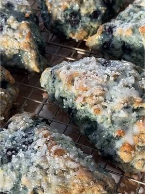 (Recipe below) These were gone in 1 day!! 🫐These are hands down the easiest & tastiest blueberry scones I’ve ever had! SAVE this recipe - trust me! •••••• Ingredients: 2 3/4 cup All Purpose Flour 1/3 cup sugar 1 tbsp baking powder 1/2 tsp baking soda 3/4 tsp salt  3/4 cup fresh or frozen blueberries (I used frozen wild blueberries) 1/2 cup FROZEN unsalted butter - *can use chilled, see below 1 cup buttermilk, cold Heavy cream for topping Optional: course sugar  Powdered Sugar Glaze: 1 cup powdered sugar 2 tbsp milk 1 tsp vanilla extract •••••• Instructions: 1. In a large bowl, whisk together flour, sugar, baking powder, baking soda & salt. 2. Grate your frozen stick of butter with a cheese grater. *Or if it is not frozen, cut into small cubes, just make sure it is cold. 3. Add butter to the flour mixture and mix with your hands or a pastry blender. The mixture should look like course crumbs. 4. Gently fold in your blueberries. 5. In a separate bowl, whisk together buttermilk and vanilla and gradually add it to the flour mixture. Stir just until the dough comes together. *you may not need all of the buttermilk if it starts to look too wet. 6. Transfer the dough to a lightly floured surface and carefully knead 4-5 times. Pat the dough into a circle. 7. Cut the circle into 8 triangles with a knife or scraper. 8. Add to a greased or lined pan. (The scones need to be cold when they go into the oven, so freeze them for a few minutes if needed) 9. Brush the scones with a little bit of heavy cream or milk, and top with course sugar. 10. Bake at 400 for 15-18 minutes or until slightly golden. 11. Let cool on a wire rack & top with powdered sugar glaze. •••••• #scones #blueberryscones #bakery #baking #breakfast #EasyRecipe #dessert 