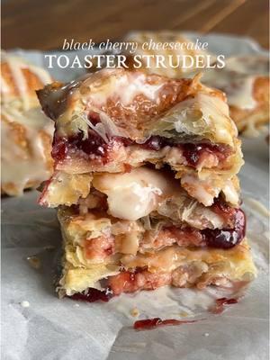 BLACK CHERRY CHEESECAKE TOASTER STRUDELS You can’t convince me that there’s anything better 🤌 Recipe below OR go to my website through the link in my bio 🤎 #Recipe Details (makes 9): Ingredients: - 2 sheets puff pastry, thawed according to instructions @Pepperidge Farm  - 2/3 cup black cherry jam (or jam of choice) - 2 tsp cornstarch - 1 egg + 1 tbsp water, for egg wash - Turbinado sugar or coarse sugar of choice, for topping @In The Raw  Cream Cheese Filling: - 8oz cream cheese, at room temperature @Philly Cream Cheese  - 1/2 cup powdered sugar - 1 tsp vanilla extract Vanilla Bean Glaze: - 1 cup powdered sugar - 1 tsp vanilla bean paste or extract - 2-3 tbsp milk of choice Instructions: Preheat the oven to 400F. Line a baking sheet with parchment paper and set aside.  Prepare the black cherry jam. In a medium bowl, whisk together the black cherry jam and cornstarch until well combined. Set aside. Start by preparing the cream cheese filling. In a large bowl, beat together the cream cheese, powdered sugar, and vanilla until light and fluffy. Transfer the mixture to a piping bag or a ziplock baggie with the corner snipped off. Set aside.  In a small bowl, whisk mix together the egg and water for the egg wash.  Assemble the toaster strudels. Lay both sheets of puff pastry on a lightly floured surface or piece of parchment paper. Cut each sheet into 9 rectangles/squares to get 18 total. Brush the rims of half (9) of the rectangles with the egg wash. Pipe ~1 1/2 tbsp of the cream cheese filling into the center of each rectangle with the egg wash. Then, spoon ~ 1 1/2 tbsp of the jam on top of the cream cheese filling, leaving ~1/4” border all around the edges. Lay the remaining rectangles/squares of puff pastry on top of the ones with the filling. Use your fingers to gently press the edges down. Then, use a fork to crimp the edges to seal. Place the toaster strudels onto the prepared baking sheet. Lightly brush the top of each strudel with the egg wash, then sprinkle with turbinado/coarse sugar. Bake at 400F for 15-18 minutes, or until golden brown and puffed. Remove from the oven and cool for 10-15 minutes. While cooling, whisk together the ingredients for the vanilla bean glaze. Drizzle the glaze over the strudels. Enjoy! #blackcherry #cherryjam #blackcherryjam #cheesecake #creamcheese #creamcheesefilling #toasterstrudel #toasterstrudels #strudel #homemade #homemadetoasterstrudel #homemadestrudel #toasterstrudelrecipe #vanillaglaze #vanillabean #vanillabeanglaze #puffpastry #puffpastryrecipe #Breakfast #brunch #desert #snack @KitchenAid 