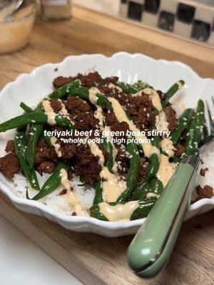 TERIYAKI BEEF & GREEN BEAN STIRFRY 🥩🫛 recipe below!  INGREDIENTS:  - 1 steamer bag of green beans  - 1 pound of ground beef  - Avocado oil for the pan  - 1/2 cup of teriyaki sauce of your choosing I’m using @nutiva)  - Rice (it’s also delicious without!) OPTIONAL TOPPINGS:  *sriracha mayo  *sesame seeds  INSTRUCTIONS:  - heat up your skillet over medium heat, add a small drizzle of avocado oil and a pound of ground beef. Break it up til it’s brown you know the drill.  - When the meat is mostly browned, absorb remaining grease with a paper towel. microwave your steamer bag of green beans.  - Add your teriyaki sauce to the pan with the ground beef. Stir until fully coated, then add in your green beans. Toss to coat. Simmer and allow the sauce to thicken, stirring every couple minutes until fully abosrbed. - Then it’s time to plate! I served over some jasmine rice, topped with sriracha mayo and sesame seeds.  SO SO SO EASY & chefs kiss everytime !!!! #stirfry #easydinner #healthydinner #highprotein #highproteinmeals #DinnerIdeas #healthydinnerideas #wholefoodsdiet #dinnerfortwo #glutenfreerecipes #dairyfreerecipes #glutenfreedairyfree @Caraway Home @Primal Kitchen Foods @H-E-B 