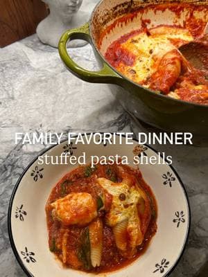 Stuffed pasta shells! A family favorite and for good reason. Recipe can be found below♥️ Enjoy! Ingredients: 1 yellow onion, diced 4 garlic cloves, minced 1 pound Italian sausage (I used mild) 2 cans crushed tomatoes (28 ounce each) Cento San Marzano is my fav. 1 1/2 tablespoons Italian seasoning 1 teaspoon crushed red pepper flakes 1 teaspoon garlic powder Salt and pepper to taste 2 handfuls of spinach 1 pound box jumbo pasta shells 15 ounce whole milk ricotta cheese 7 ounce gouda cheese, shredded 8 ounce fresh mozzarella cheese, torn In a large oven safe skillet over medium heat, add 2 tablespoons of olive oil then your onions and salt and pepper, and sauté for 5 minutes. Add your minced garlic and sauté for another minute. Add your Italian sausage, breaking it up using your spatula, and cook until sausage is browned. Once sausage is cooked reduce heat to low and add in your crushed tomatoes, Italian seasoning, garlic powder, crushed red peppers. Simmer for 10 minutes to allow sauce to thicken. While your sauce is thickening, boll your pasta shells in boiling water until al dente. Once sauce has thicken, add in your spinach and mix. Cook for another 5 minutes to allow the spinach to wilt. Combine ricotta cheese, shredded gouda, and torn basil in a large gallon ziplock bag. Massage cheese together then push to one corner of the bag and cut the tip of the bag to use for piping. Pipe your cheese into each shell. I measure with my heart with cheese but if I have to add a measurement I would say about 1 tablespoon in each shell. Place your cheese stuffed shell in the skillet on top of the sauce. Tear fresh mozzarella on top of the shells. Transfer the skillet to your oven and bake in the oven at 350' for 30 minutes. I cook with the lid on for 15 minutes then take the lid off the last half of cooking. At the end set your oven to boil for a few minutes to get your pasta nice and crunchy. Make sure to keep an eye on it so it doesn't burn. Let your pasta rest for 10 minutes before serving and enjoy! #stuffedshells #comfortfood #familydinner #kidapproved