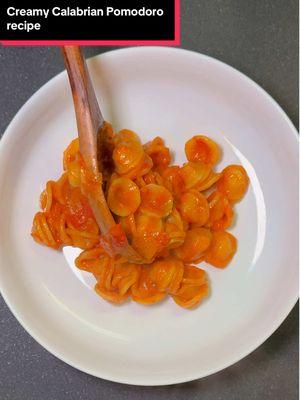 Creamy Calabrian Pomodoro pasta is a lighter twist on spicy vodka and I love it sm 🥹🔥 recipe deets below ⬇️ You’ll need: - 8oz pasta of choice (I used orecchiette) - 1 can whole pealed pomodorini tomatoes - 1 onion or 2 shallots (sliced) - 2-4 cloves garlic (whole & crushed) - 1/3 cup (or less) heavy cream - 1/2 tsp crushed Calabrian chilis  - Olive oil - 1 tbsp butter  - Fresh basil - Fresh grated parmesan cheese - Pasta water - Salt & pepper To make: 1. Cook down onions or shallots in olive oil, until translucent and soft, then add in garlic and cook for 1 min (medium heat) 2. Add canned tomatoes, mix around & crush, then cover pan and let simmer on medium/low for 10 min  3. Uncover, add Calabrian chilis & salt/pepper (hold off on a lot of salt if your pasta water is very salty), then add heavy cream (a little at a time until you reach desired color)  4. Add lots of grated parmesan and fresh torn basil, then blend until smooth but a little chunky with an immersion blender 5. Add pasta to salted boiling water and cook 6. Reserve about 1 cup of pasta water and drain pasta 2 min before the cook time written on the package 7. Add cooked pasta and a splash (or a few) of pasta water, butter, then mix around 8. Enjoy with extra basil & parm! #nyfoodsharings #pastarecipe #pomodoro #pastatiktok 