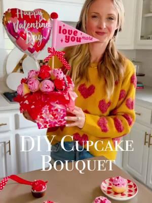 This darling Cupcake Bouquet is so easy to make and can brighten anyone’s Valentine’s Day! 💕🧁💐  I love this idea for friends, teachers, coworkers, or neighbors! The best part? No baking is required and it can be made on a super low budget! Ingredients: -Cupcakes – Either homemade or store-bought. I’d recommend mini cupcakes in pink, red, and white in order to add more and have a fuller look. -Red Mini Cupcakes (from Target) -Pink Mini Cupcakes (from Target) Supplies: I purchased almost everything for my Cupcake Bouquet from Target for under $5!  -Heart Container (You could also use a bucket as well!)  -White Foam Sphere – I got mine from Michael’s  -Valentine’s Theme Tissue Paper from Target -Toothpicks (to secure the cupcakes to the sphere) -Valentine’s Day Balloons (from Amazon) -The cute banner is from the Target $3 spot! Directions: 1. First, stuff the base container with tissue paper. I like mine to overflow on the sides a bit. 2. Next, wrap the sphere in tissue paper and place in the base container. 3. Using toothpicks, add the mini cupcakes. 4. Top with cute balloons or banners! #ValentinesDay #valentine #valentines #cupcake #bouquet #cupcakebouquet #gift #giftforher #flower #flowers 