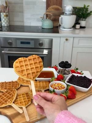 Waffle Pops! ❤️🧇  everything is more fun to eat on a stick! (According to my kids at least) - I used my mini waffle maker and just added a popsicle stick before closing and it worked perfectly. I put them on a cutting board with some waffle fixins but you can also just serve normally.  I used my heart waffle maker for a Valentines breakfast but you can use any shape you like! #waffles #breakfast #momhacks #momhack #breakfastideas #kidsbreakfast #ValentinesDay #valentinesdaybreakfast 