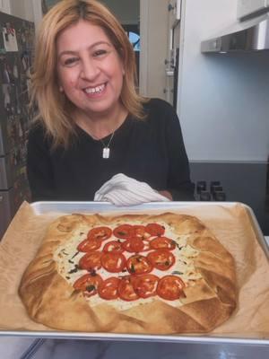 ZA’ATAR CHEESE GALETTE! This easy-to-make cheese galette is absolutely delicious! The crispy dough on the outside and the creamy filling on the inside make it irresistible. 😍 . Recipe: Ingredients: 1 unit of thawed rolled short dough (@tnuvausa; the package contains 2 units, but we will use 1 for this recipe) Cheese and Za’atar Filling Ingredients: 1 cup shredded mozzarella 1 cup shredded feta cheese 1 package ricotta cheese (16 oz / 453g) 1 teaspoon salt 1/2 teaspoon ground black pepper 1/2 teaspoon garlic powder 1 heaping teaspoon za’atar 1 tablespoon fresh oregano leaves 1 tablespoon olive oil Instructions for the filling: Combine all the filling ingredients in a bowl and mix well. For the Topping: 3 Roma tomatoes, sliced 1/2 teaspoon flaky salt 5-6 fresh oregano leaves Method: 1. Preheat the oven to 400°F (200°C). 2. Cut a piece of baking paper to fit your baking pan and place it on your kitchen surface. Sprinkle 1 tablespoon of flour over the paper. 3. Roll out the thawed dough on the floured baking paper, adjusting as needed to about 1/4 inch thickness. 4. Spread the cheese filling in the center of the dough, leaving a 2-inch border around the edge. 5. Arrange the sliced tomatoes on top of the cheese filling. Sprinkle with flaky salt and fresh oregano leaves. 6. Fold the edges of the dough over the filling, overlapping each fold slightly to form a crust. 7. Bake in the preheated oven at 400°F for 30 minutes, or until the crust is golden brown.  Enjoy! Ruhama🤍 #galette #savory #bakingrecipe #ricotta #zaatar #feta #mediterraneanfood #fypシ #fy #ruhamasfood 