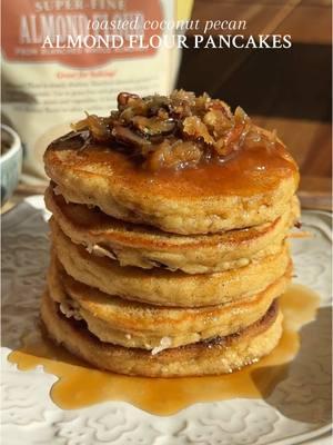 TOASTED COCONUT PECAN ALMOND FLOUR PANCAKES #ad Quite possibly the most comforting stack of pancakes you could ask for to start you day ✨ They’re soft and fluffy thanks to @Bob’s Red Mill Super Fine Almond Flour, are toasty and nutty, and served perfectly with a drizzle of maple syrup 😌 Recipe below OR go to my website through the link in my bio 🤎 #Recipe Details (makes 5-8): Toasted Coconut & Pecans  - 1 cup chopped pecans - 1 cup shredded coconut - 1/2 cup maple syrup - 3 tbsp salted butter Almond Flour Pancakes: - 1 cup @bobsredmill Super Fine Almond Flour - 1 tsp baking powder - 1/2 tsp cinnamon - 1/4 tsp salt - 2 eggs, room temp - 1/4 cup milk of choice, room temp - 1 tbsp maple syrup - 1 tbsp salted butter, melted & slightly cooled - 1/2 tsp vanilla extract Instructions: Preheat the oven to 325F. Evenly spread the shredded coconut and chopped pecans onto a large baking sheet lined with parchment paper. Bake at 325F for 5-7 mins, mixing once, until the coconut and pecans are slightly toasted. Remove from the oven and set aside. Make the pancakes. In a medium bowl, whisk together the almond flour, baking powder, cinnamon, and salt. In a separate large bowl, whisk together the eggs, milk, maple syrup, melted butter, and vanilla until well combined.  Pour the dry ingredient mixture into the wet, and mix until just combined. Allow the batter to sit for 5 mins to thicken. If the batter is too thick, add 1 tbsp more milk at a time. Heat a non-stick pan over medium heat, and grease with butter. Use a 1/4 cup measuring cup to pour portions of the pancake batter onto the pan. Sprinkle the pancakes with the toasted coconut and pecans. Cook until the bottoms have turned golden brown (2-3 mins). Flip carefully, and cook until golden on the underside (~2-3 more mins). Continue making pancakes until the batter Is gone. With the remaining toasted coconut and pecans, add them to a small pan over medium-high heat, along with the maple syrup and butter. Mix and allow to come to a slight boil, and let it bubble for 3-5 mins, until the mixture is thickened and gooey. Serve the pancakes warm with the gooey coconut pecan topping and extra maple syrup, if desired. Enjoy! #bobsredmill #pancakerecipe #Breakfastrecipe