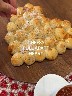 Cheesy stuffed pull apart rolls in the shape of a heart Ingredients -store bought pizza dough (I used 2 packs) -mozzarella cheese -Butter -Parmesan -Italian seasoning -flaky sea salt Bake at 400F for 18-20 minutes Until fully cooked through #valentinesdayfood #galentinesfood #valentinesdaypizza #valentinesdayappetizer#valentinesfood #pizza #pullapartbread #garlicbread #rolls #garlic #garlicherb #mozzarella #pizzadough #breadrolls #vegetarianappetizers #cheeseappetizer#cheesypullaparts #pullapartgarlicbread