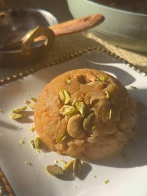 Makhandi Halwa. My second most favorite sooji halwa on this planet earth! Semolina soaked in milk then cooked in caramelized  sugar is what gives this dessert its special flavor.  Ingredients: 1 cup sooji (Semolina) 2 cups milk  4 crushed cardamom seeds  1 cup ghee  8-10 Cashews 5-6 Almonds  1 tbsp Raisins  1 oz sliced dry coconut  1 cup sugar  Pistachio for garnish  Instructions: In 1 cup sooji (Semolina), pour 2 cups milk (lukewarm). To it add 4 crushed cardamom seeds. Soak for an hour. You will then need 1 cup ghee. Now add 1/4 cup of ghee and toast Cashews, Almonds, Raisins and Sliced dry coconut. Toast until slightly golden. Remove and then add 3/4 cup ghee. Now add 1 cup sugar. Slowly cook until the sugar caramelizes. Then gently and carefully add semolina/ milk mixture to the caramelized sugar.  Now cook until all the milk is evaporated and observed by Semolina. Now decorate with cashews and pistachios by placing some at the bottom of a bowl. Then spooning halwa on top. Press it in gently with a spoon. Finally flip and serve with chai. Enjoy! #halwa #makhandi #makhandihalwa #halwarecipe #meetha #sweet #dessert #foodtiktok #FoodTok #sugar #pakistanifood #shaadimubarak #shaadiseason #shaadi #gharkakhana #pakistani_tik_tok #pakistanitiktok #tiktokindia #tiktokpakistan #punjabitiktok #pind #punjabi #punjabitiktok 