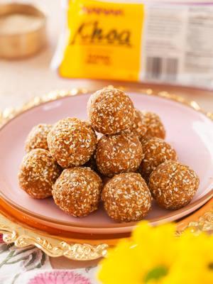 Celebrate Lohri with the irresistible goodness of Til Khoa Ladoo! 🌟 These soft, nutty treats are made with roasted sesame seeds 🌰, rich Nanak khoa 🧀, and natural jaggery 🍯, creating a delightful balance of flavors. Infused with the warm aroma of cardamom 🌿, each ladoo offers the perfect blend of crunchy sesame and melt-in-your-mouth creamy khoa. A festive indulgence that’s as nourishing as it is delicious, these ladoos are sure to bring joy and sweetness to your Lohri celebrations! 🎉😋 #nanakfoods #TilKhoaLadoo #sweettreat #festiveindulgence #sesamegoodness #nourishingdelights #indiansweets #healthydessert #jaggerygoodness #ladoolover #foodiefavorites #wintersweet Recipe Ingredients (Makes 10-12 ladoo) ● ¾ cup white sesame seeds (til) ● 1 cup Nanak khoa (mawa), grated ● 1/2 cup jaggery, chopped into small pieces ● 1/4 teaspoon green cardamom powder ● 1 teaspoon ghee (optional, for greasing hands) Method Heat a heavy-bottomed non-stick pan on medium heat and dry roast the sesame seeds until they turn light golden and aromatic. Stir continuously to avoid burning. Remove the seeds from the pan and let them cool. Grind ⅓ rd of the seeds coarsely to make the ladoos smoother, while keeping the rest whole. In the same pan, add the khoa and cook on low heat for 3–5 minutes, stirring constantly until it softens.Set aside the cooked khoya. In the same pan, add the jaggery and 2–3 tablespoons of water. Heat on low flame until the jaggery melts completely into a syrup. Do not overcook the syrup. Reduce the heat to low and add the roasted sesame seeds, cardamom powder and khoa to the melted jaggery. Mix well. Stir continuously until all ingredients are well combined to form a soft mixture. Remove from heat and let it cool slightly, just enough to handle with your hands. Don’t let the mixture cool completely. Grease your palms with ghee. Take small portions of the mixture and roll them into smooth, round ladoos. Repeat for the remaining mixture. Allow the ladoos to cool completely before storing them in an airtight container.