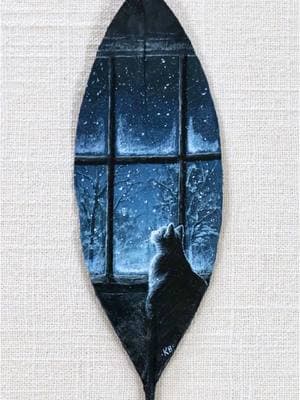 “Snow Watcher” Painted on a preserved magnolia leaf ❄️ I admit this painting may have been a little wish to usher in the snow here in NC… it’s been 3 years since we’ve seen any in my part of the state! I’m hoping that my little buddy Franklin (who kindly modeled for this painting) might get to see his first snow this weekend—not that he’d like it very much 🐈‍⬛ #natureart #leafart #landscapepainting #leafpainting #theleafpainter #evergreen 