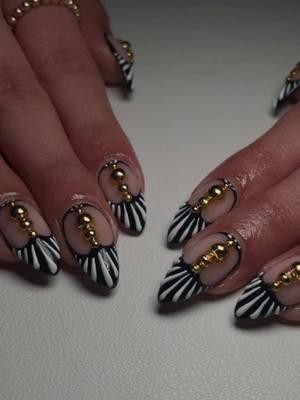 Birthday nails fit for a queen 👑✨ Watch the process behind these bold, black-and-white striped nails with gold bead accents—perfect for my client’s special day! 🖤💛 Elevating birthday glam one nail at a time. Inspo: necta_nails #birthdaynails #dallasnailtech #dallasnails #txnails #planonailtech #planonails #boldnaildesigns #nailartprocess #nailtutorial #statementnails #nailinspo #blackandwhitenails 