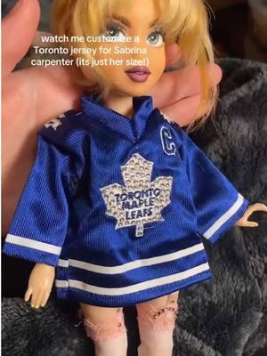 I wish I could remember who told me about these miniature jerseys! They’re so cute tysm for helping me find it! It fits the Sabrina carpenter dolls perfectly 💋 #ooakdoll #customdoll #bedazzling #shortnsweet #torontomapleleafs #sabrinacarpentertour #sabrinacarpenter #bratzdoll #dolltransformation #shortnsweettour #oneofakind #dolls #dolltok 