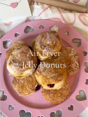 Air Fryer Jelly Donuts with just 4 ingredients! 🍩🍓 These make for a warm, fluffy; and delicious Valentine’s Day breakfast for your loved one!💘 Ingredients: - 1 can refrigerated biscuit dough  - 1/2 cup melted butter  - 1/2 cup granulated sugar - 1/2 cup raspberry jelly  Directions: 1. Preheat your air fryer to 350°F. Lightly spray basket with oil spray.  2. Arrange biscuits in a single layer in the air fryer basket.  3. Lightly spray the biscuits with oil spray. Air fryer for 5-6 minutes or until golden brown.  4. While the donuts are cooking, add the jelly to a piping bag fitted with a king tip.  5. Remove biscuits from the air fryer and gently brush melted butter on all sides.  6. Toss the donuts in the sugar to coat.  7. Stick the tip of the piping bag into the center of the donut and squeeze the jelly into the donut.  8. Enjoy! 🍩 #valentinesfood #valentinesidea #valentinesrecipe #valentinesdonut #jellydonut #valentines #valentinesbreakfast #airfryerdonut #easydonutrecipe #ValentinesDay #vdayfood #vdayrecipe #vdaydecor #easyvdayrecipe #easybreakfastidea #airfryerrecipe #fyp 