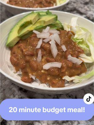 The EASIEST comfort food that comes together in about 20 minutes!  Cheesy Pinto Beans Ingredients  1 cup Rice Oil ¼ tsp Red Pepper Flakes ½ tsp Garlic Powder 2 cans Pinto Beans (about 30 ounces total) 1 tsp Ground Cumin 1 tsp Smoked Paprika ¼ tsp Black Pepper ½ cup Cheddar, shredded (or any cheese) Avocado, for garnish Onions, diced, for garnish  Shredded Cabbage or lettuce, for garnish Hot sauce, optional  Instructions  1. Cook rice as directed and set aside.  2. Meanwhile, in a medium pot, heat oil over medium heat. Add red pepper flakes and garlic powder and sauté until fragrant, about 15 seconds. Be careful not to burn the garlic.  3. Add pinto beans, liquid and all and stir, with a hand blender or potato masher, blend half of the beans. Season with cumin, paprika, and pepper. Stir and bring to a simmer. 4. Stir in cheese until melted. Serve on top of rice with optional toppings and enjoy!  Recipe adapted from Budget Bytes #mealsonabudget #cheapmeals #beansandrice #EasyRecipe #DinnerIdeas #yum #budgetmeals #budgeting #mealplanning 