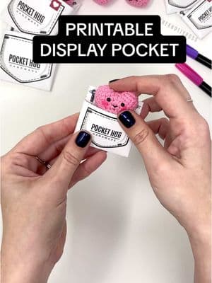 Showing how easy it is to use my little printable display pockets for your pocket hugs. Best part is it doesnt require any tape or glue AND it’s adjustable! #theknottyboss #knottyboss #crochetpackaging #pockethug #valentinesdaygift #crochetgift #crochetheart #pocketheart #handmade #crochettiktok #yarntok #yarn #modernmaker #handsatwork 