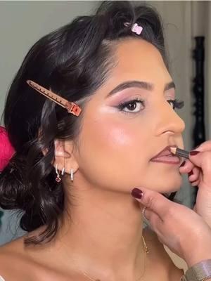 Our fresh faced beauty @riyampatel for her Sangeet paired with a romantic low updo and crimson roses. #sangeetoutfit #bridalmakeup #indianwedding