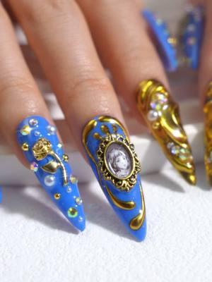 For those who revel in the exquisite and seek to wear the grandeur of history on their fingertips, ✨H377 is your key to an era of sophistication.✨ Royal blue drenched in gold, adorned with pearls and ornate cameos. These nails are your gateway to timeless sophistication and baroque splendor. 🛒 Click on Orange cart to get yours TODAY! #Nailtok #TrendingNails #BaroqueNails #LuxuryPressOns #LovfulNails #ElegantStyle #TimelessBeauty #wearableart 